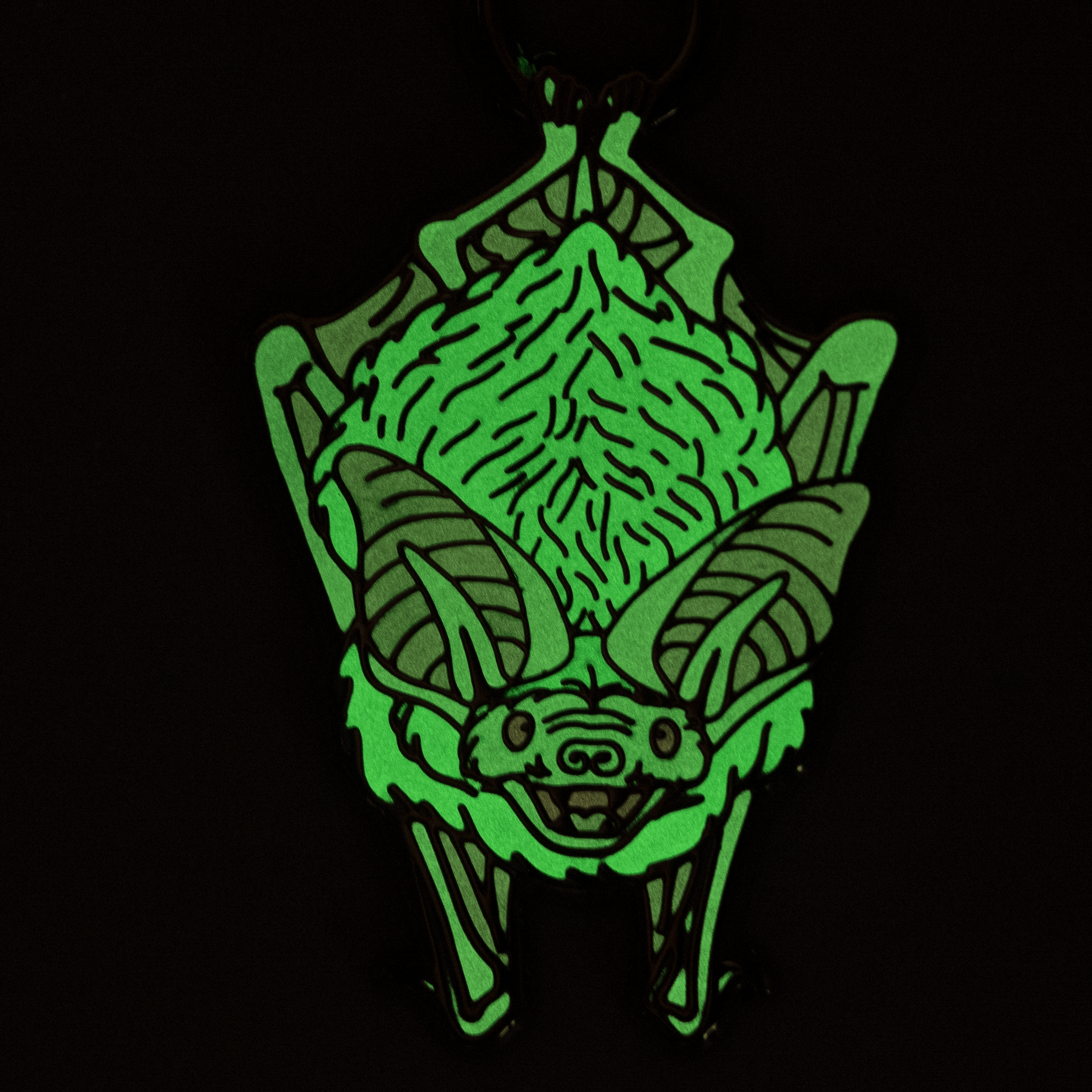 Bat ornament glowing green in the dark.
