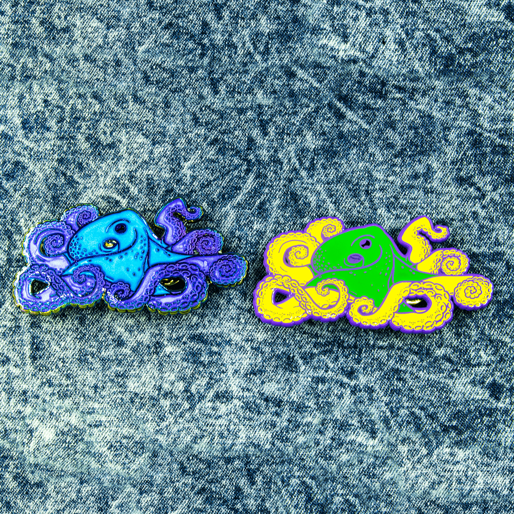 Two large octopus enamel pins sit above a stonewashed denim skirt.