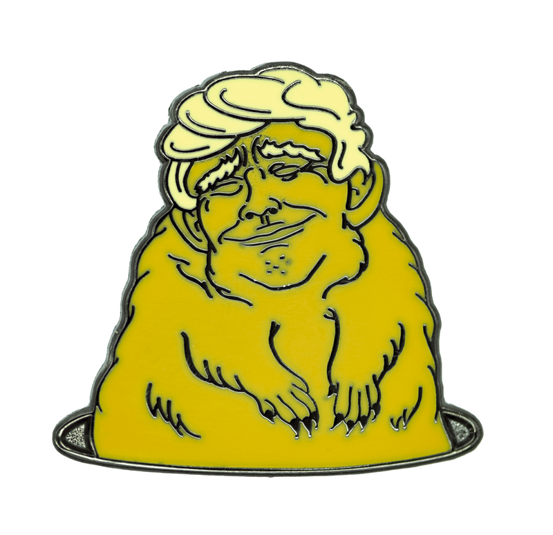 An enamel pin of an orange gopher with the face of Donald Trump, popping out of a hole.