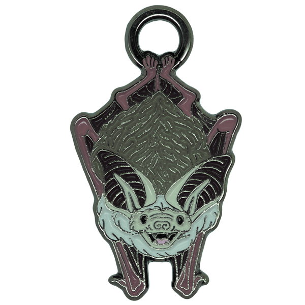 A soft enamel charm of a friendly, smiling brown bat danging from a small ring.