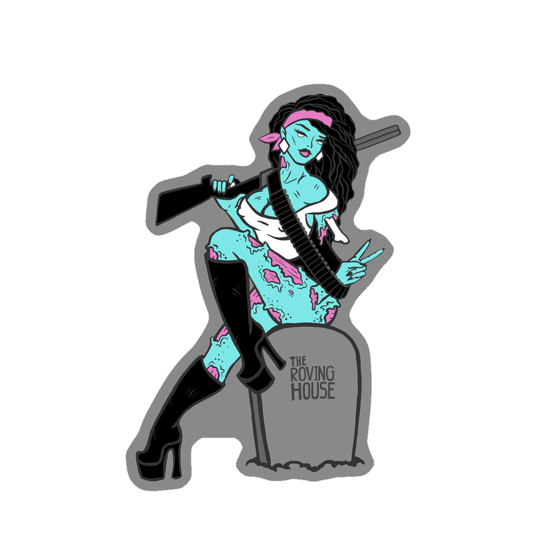 A vinyl sticker of an attractive, buxom zombie woman with light blue skin, white eyes, black hair, and pink flesh wounds. She sits on a grey gravestone that reads "THE ROVING HOUSE", holding a shotgun.