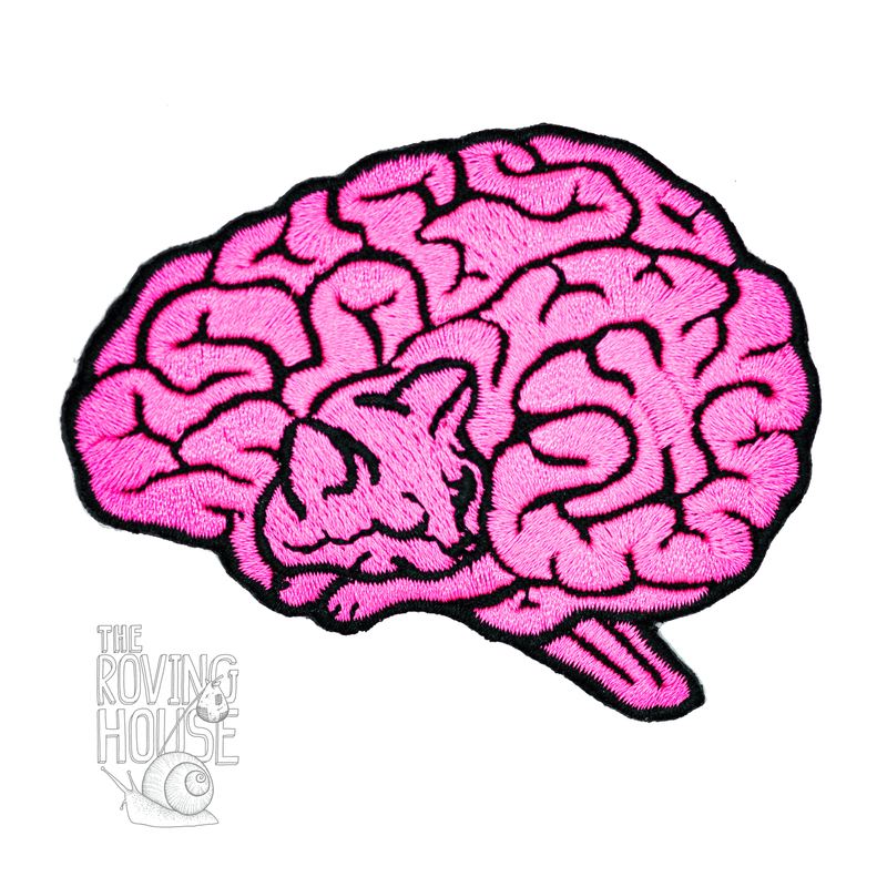 A soft embroidered neon pink and black patch in the shape of a human brain. Upon closer inspection, the lines of the brain resemble a sleeping cat.