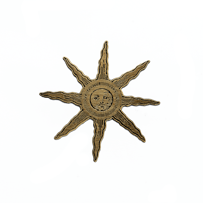 A gold metal sun-with-a-face pin, with antique artwork from the Flammarion Engraving.