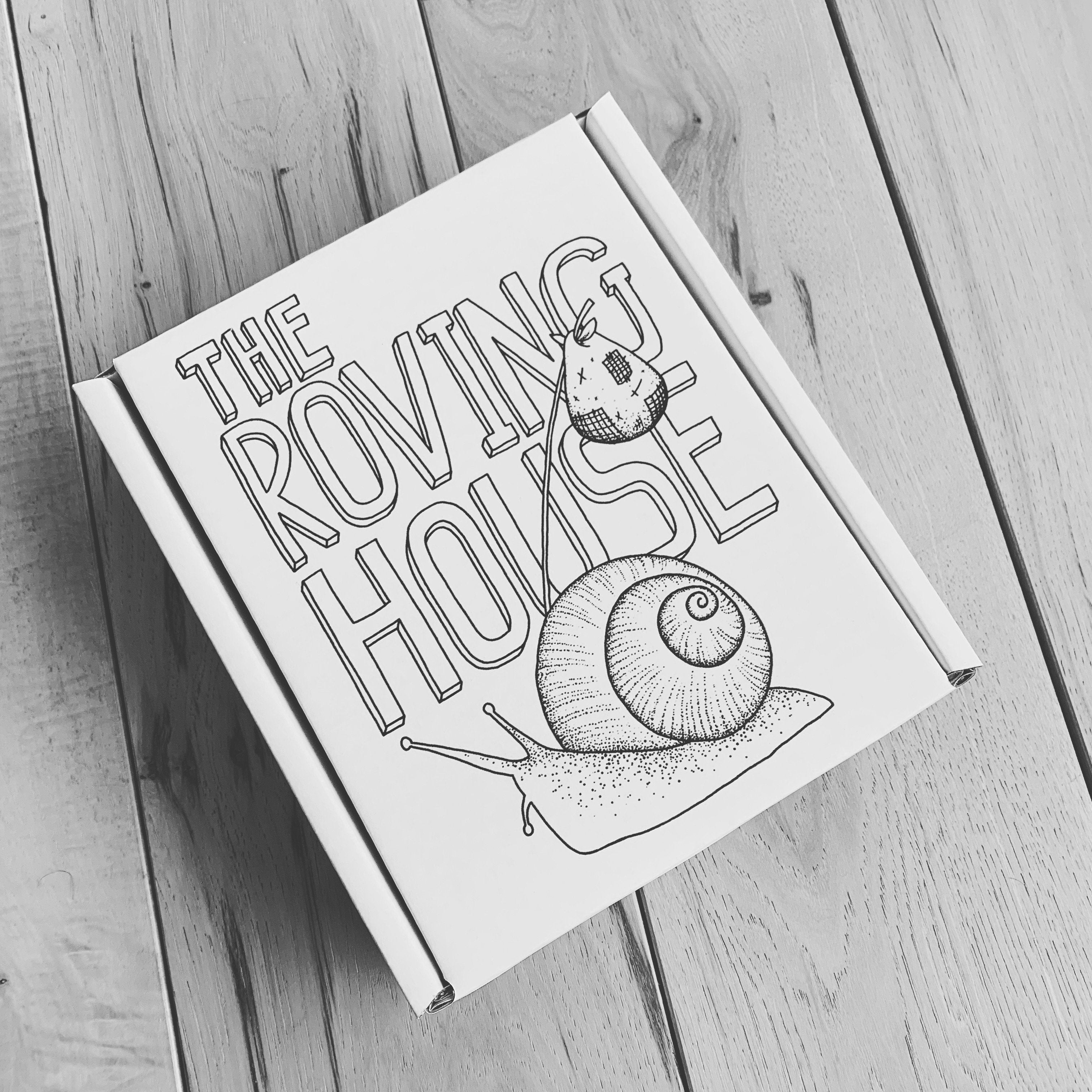 A black & white image of a white carboard box featuring our snail logo, sitting on a hardwood floor. The box is sealed, hiding its contents.