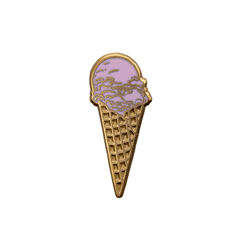 A gold metal and pink enamel pin of a strawberry ice cream waffle cone.