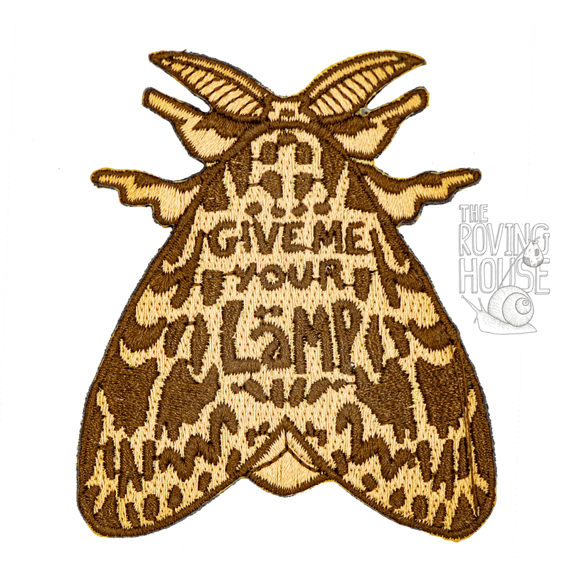 An embroidered iron-on patch in the shape of a brown Lymantria dispar moth, whose wing markings contain the text "GIVE ME YOUR LAMP".