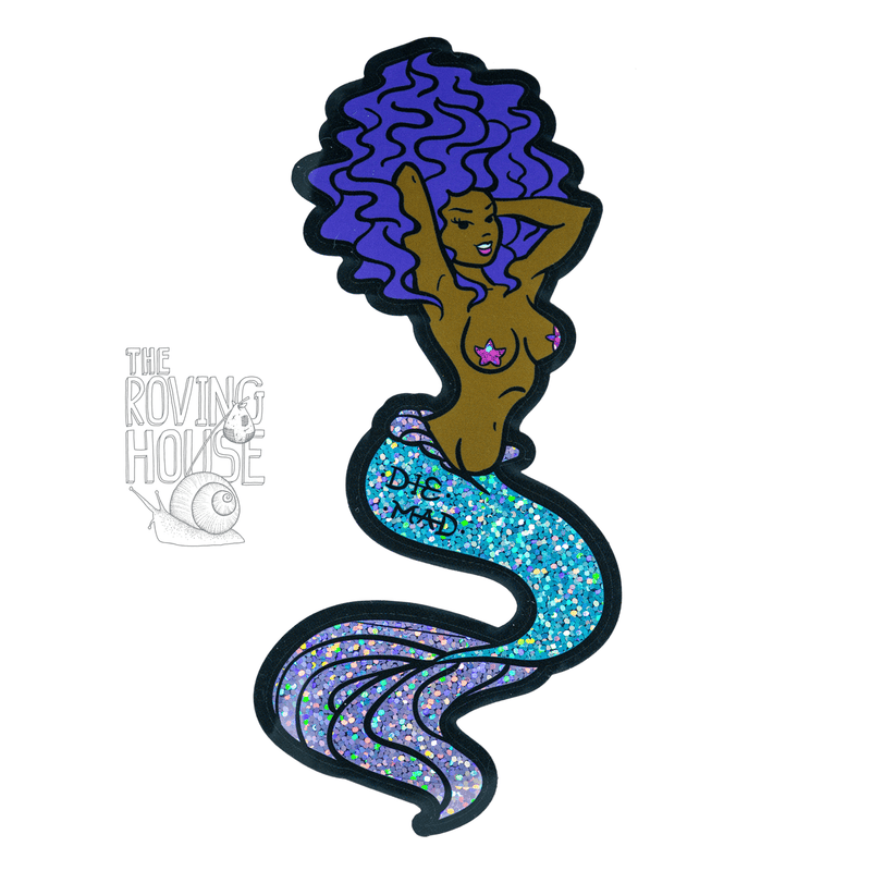 A glitter vinyl sticker of a black femme mermaid with purple hair. She has a tattoo on her fish-butt that says "DIE MAD".