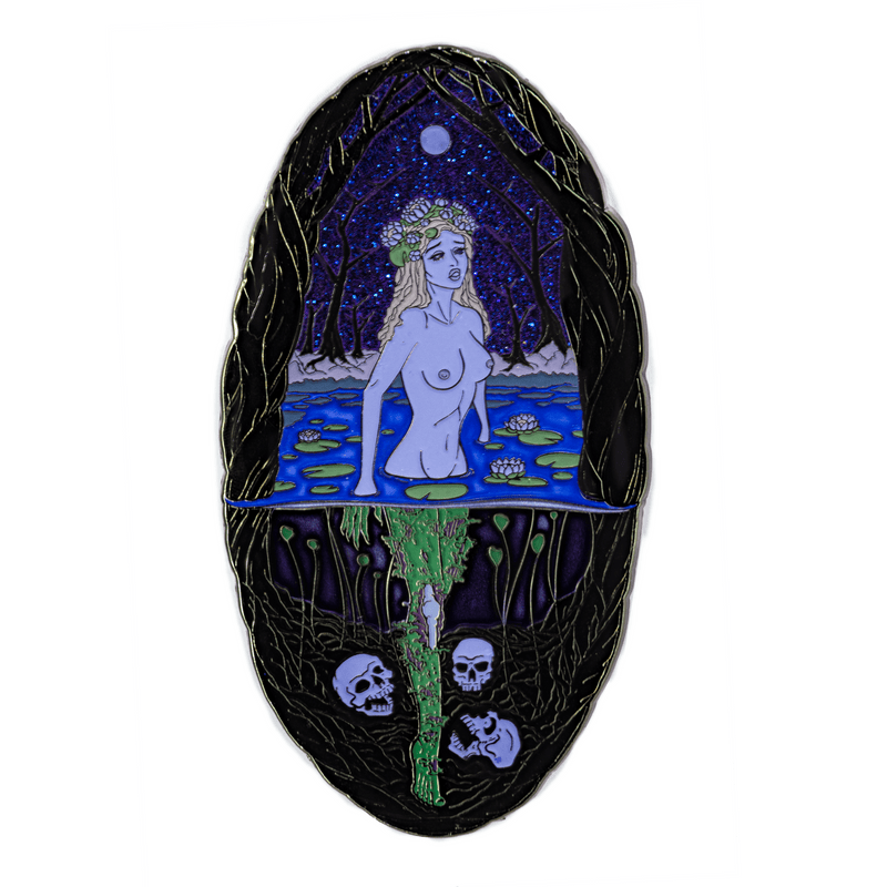 A large enamel pin of a mythological Rusalka in a swamp during the night time, with the full moon overhead. Above the water, she appears as a young, blonde, pale woman wearing water lilies in her hair. Below the water, her legs are green and zombie-like, and three skulls surround her feet. The sky glitters blue and purple.