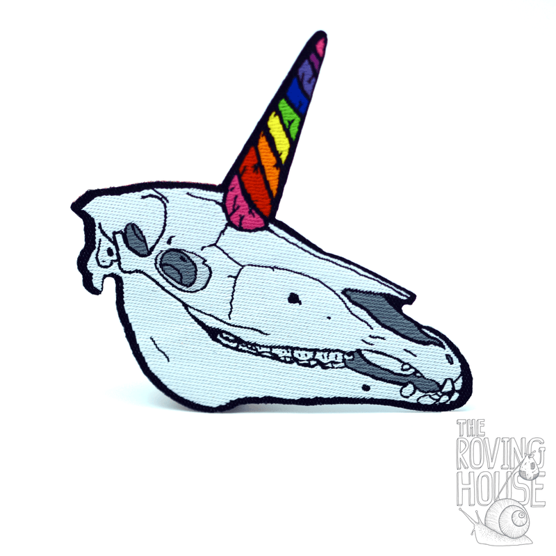 A woven patch of a unicorn skull with a rainbow swirled horn.