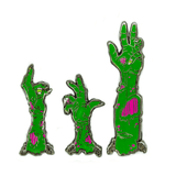 A set of three zombie arm pins, appearing to come up from the ground. Their skin is green, and their flesh wounds are neon pink.